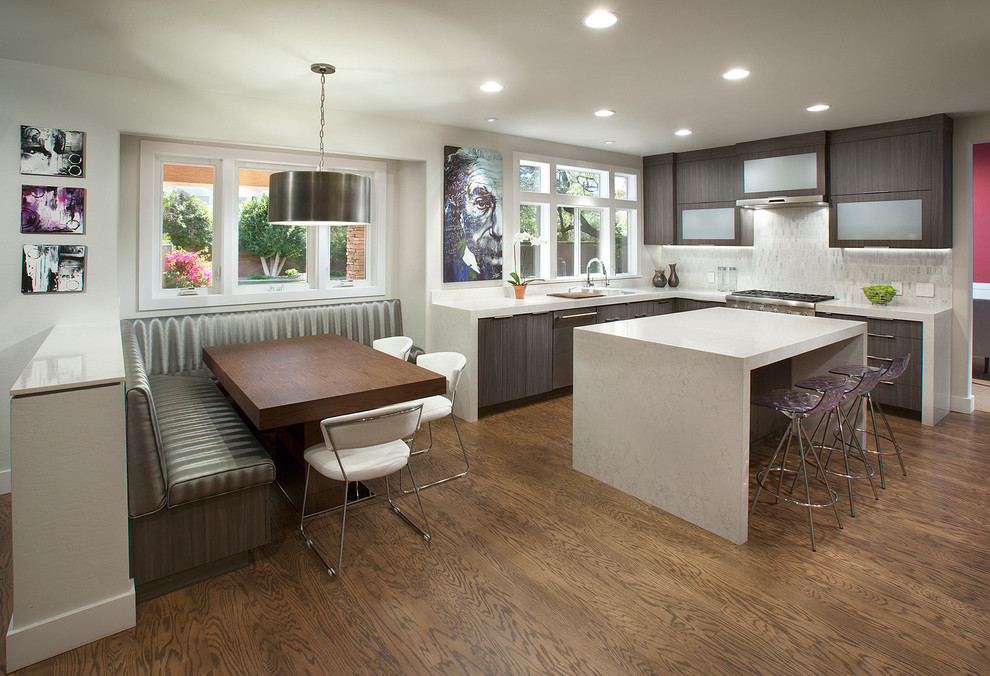 Design ideas for a large contemporary l-shaped open plan kitchen in Phoenix with a submerged sink, flat-panel cabinets, grey cabinets, engineered stone countertops, white splashback, mosaic tiled splashback, stainless steel appliances and medium hardwood flooring.