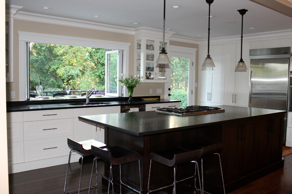 Open concept kitchen - large traditional l-shaped dark wood floor open concept kitchen idea in Vancouver with an undermount sink, shaker cabinets, white cabinets, granite countertops, stainless steel appliances and an island