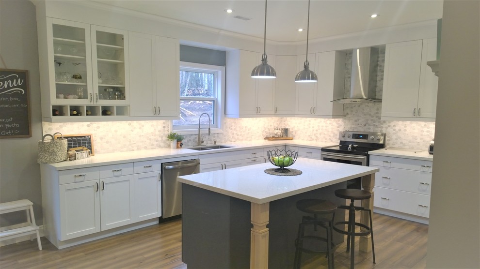 Mid-sized arts and crafts l-shaped medium tone wood floor and brown floor eat-in kitchen photo in Other with a double-bowl sink, shaker cabinets, white cabinets, quartz countertops, multicolored backsplash, ceramic backsplash, stainless steel appliances and an island