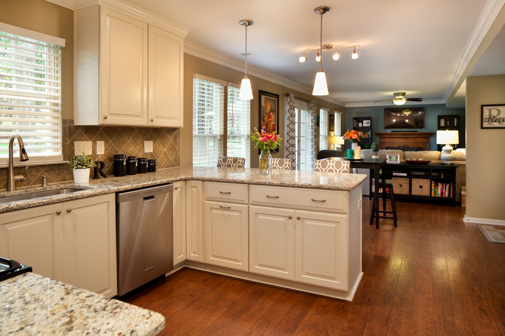 Inspiration for a small transitional u-shaped eat-in kitchen remodel in Charlotte with a single-bowl sink, raised-panel cabinets, white cabinets, granite countertops, brown backsplash, ceramic backsplash, stainless steel appliances and a peninsula