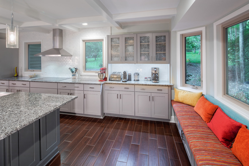 Example of a large trendy ceramic tile and brown floor eat-in kitchen design in Raleigh with a farmhouse sink, shaker cabinets, white cabinets, granite countertops, white backsplash, ceramic backsplash, stainless steel appliances, an island and gray countertops