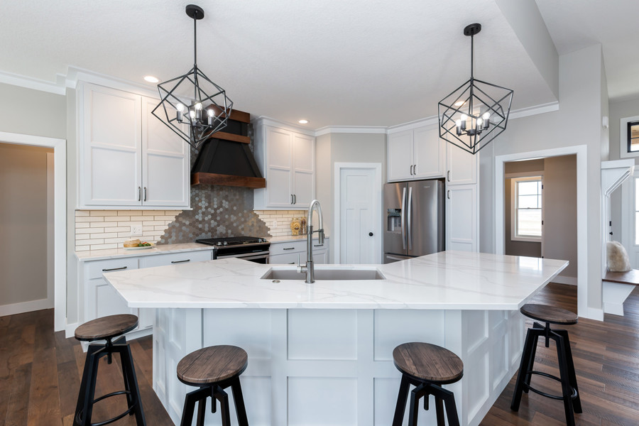 Large transitional single-wall medium tone wood floor and brown floor open concept kitchen photo in Other with an undermount sink, flat-panel cabinets, white cabinets, quartz countertops, beige backsplash, mosaic tile backsplash, stainless steel appliances, an island and white countertops
