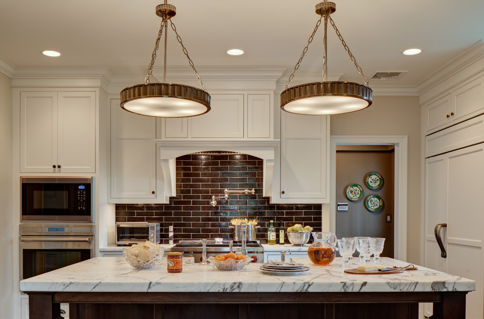 Example of a classic kitchen design in Newark with white cabinets and brown backsplash