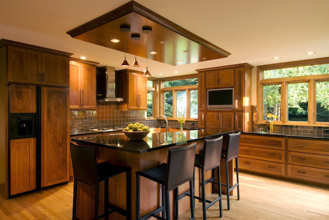 Example of a large transitional galley medium tone wood floor open concept kitchen design in Other with shaker cabinets, granite countertops, brown backsplash, paneled appliances, an island, a double-bowl sink, dark wood cabinets, ceramic backsplash and black countertops