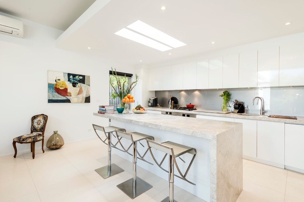 Kitchen - contemporary kitchen idea in Melbourne with an undermount sink, flat-panel cabinets, white cabinets, glass sheet backsplash and an island