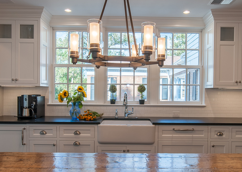 Large elegant l-shaped dark wood floor and brown floor open concept kitchen photo in DC Metro with a farmhouse sink, recessed-panel cabinets, white cabinets, quartz countertops, white backsplash, ceramic backsplash, stainless steel appliances and an island