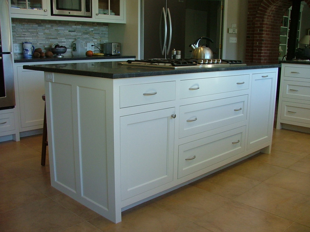 Example of a classic u-shaped eat-in kitchen design in Portland Maine with recessed-panel cabinets, white cabinets, granite countertops, white backsplash and stainless steel appliances