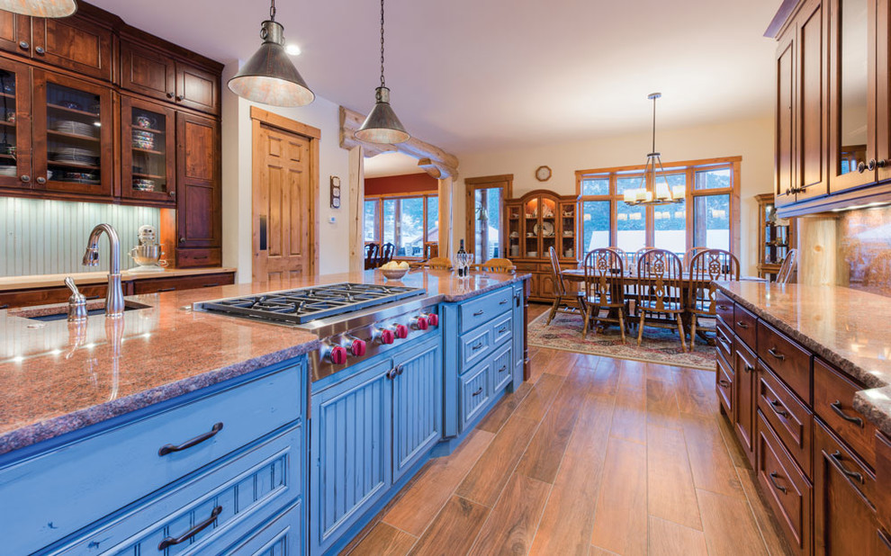 Inspiration for a large timeless u-shaped medium tone wood floor eat-in kitchen remodel in Denver with raised-panel cabinets, blue cabinets, granite countertops, multicolored backsplash, stone slab backsplash, stainless steel appliances and an island