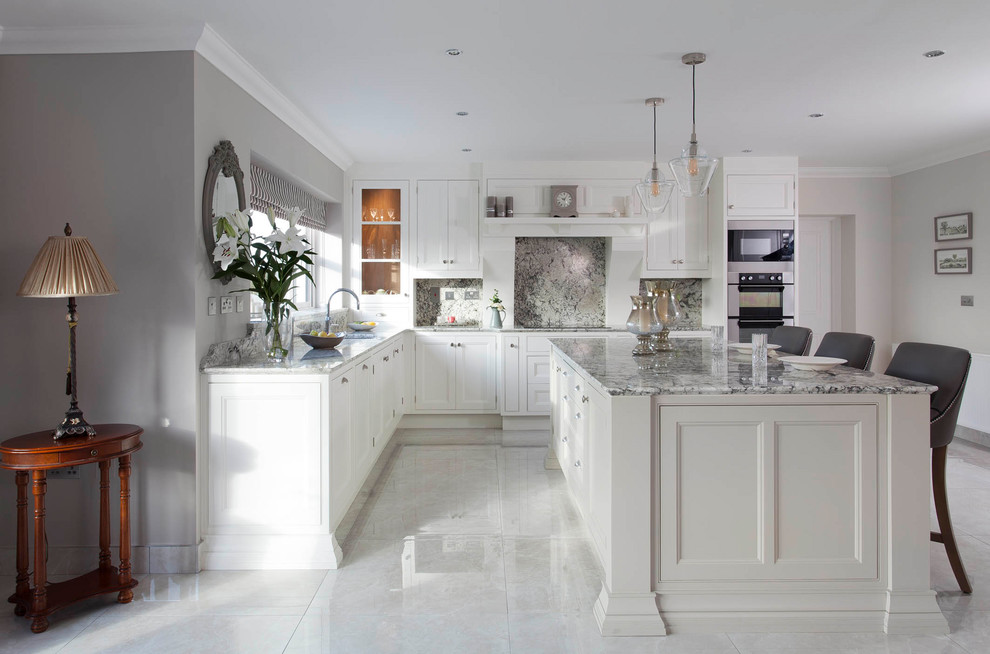 Large traditional l-shaped kitchen/diner in Other with a submerged sink, beaded cabinets, white cabinets, granite worktops, grey splashback, stone slab splashback, stainless steel appliances, porcelain flooring, an island and grey floors.