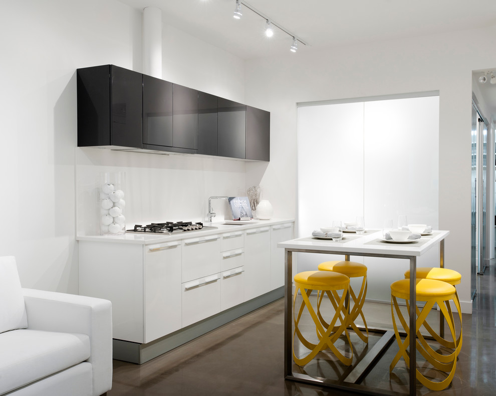Eat-in kitchen - modern single-wall eat-in kitchen idea in Vancouver with an undermount sink, flat-panel cabinets, white cabinets, solid surface countertops, white backsplash, ceramic backsplash and stainless steel appliances