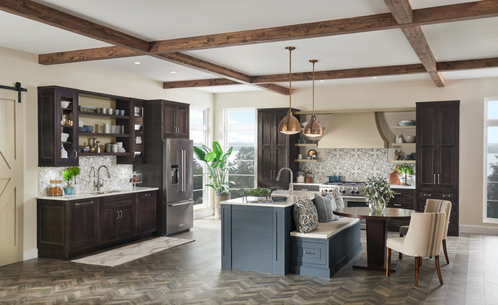 Design ideas for a large traditional l-shaped open plan kitchen in Sacramento with beaded cabinets, brown cabinets, engineered stone countertops, grey splashback, porcelain splashback, stainless steel appliances, vinyl flooring, an island, multi-coloured floors and white worktops.