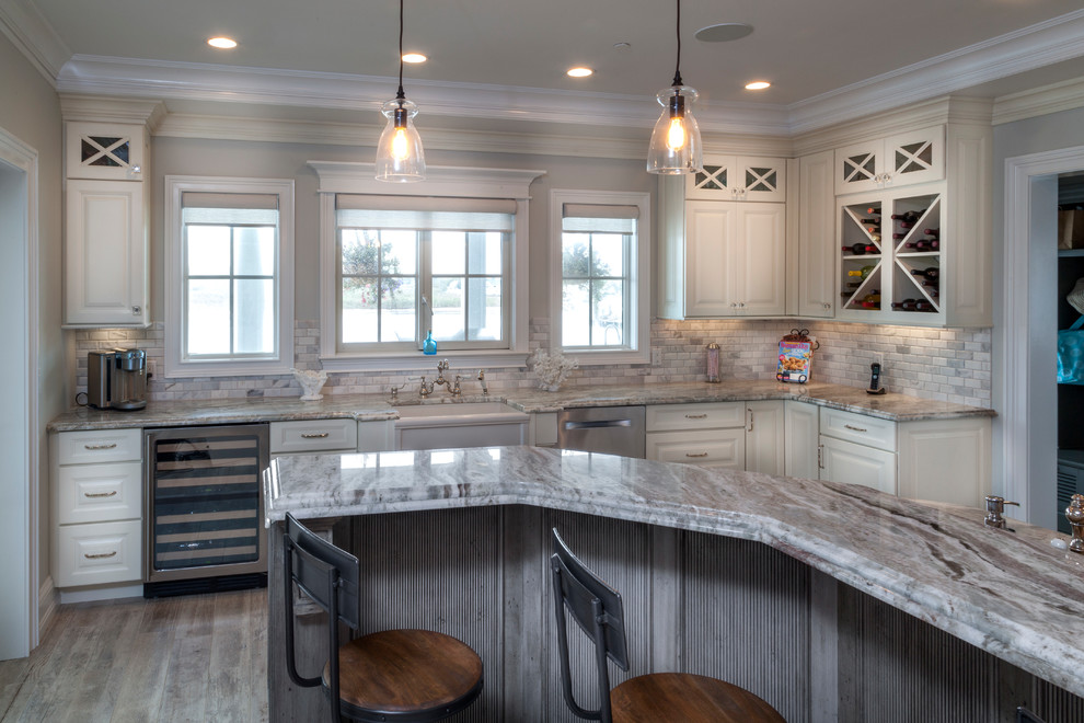 Inspiration for a large timeless u-shaped ceramic tile eat-in kitchen remodel in New York with a farmhouse sink, raised-panel cabinets, white cabinets, granite countertops, gray backsplash, porcelain backsplash, stainless steel appliances and an island