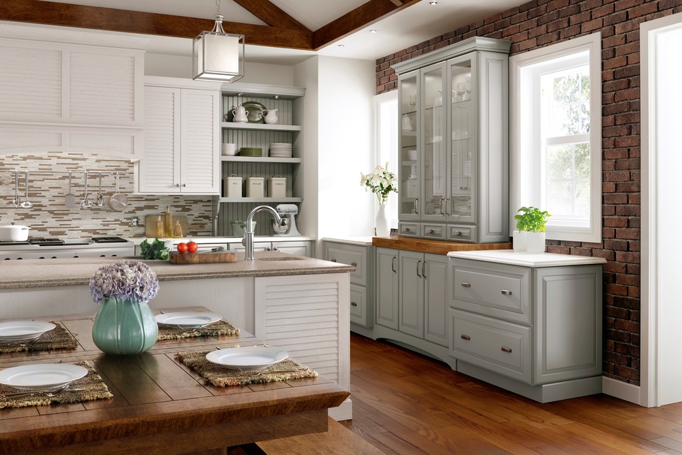 Photo of a medium sized classic l-shaped kitchen/diner in Minneapolis with a submerged sink, louvered cabinets, white cabinets, engineered stone countertops, multi-coloured splashback, matchstick tiled splashback, medium hardwood flooring, an island, brown floors and brown worktops.