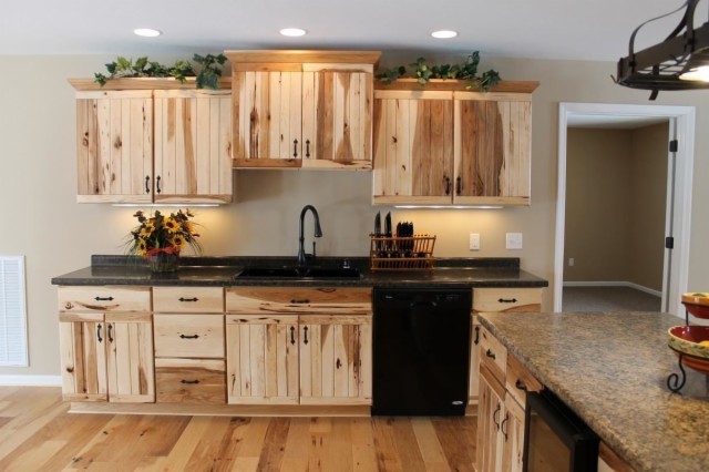 Example of a mid-sized mountain style u-shaped light wood floor open concept kitchen design in Nashville with a double-bowl sink, light wood cabinets, laminate countertops, black appliances and an island