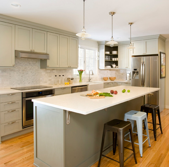Medium sized traditional l-shaped kitchen in Boston with a built-in sink, shaker cabinets, grey cabinets, recycled glass countertops, white splashback, stone tiled splashback, stainless steel appliances, light hardwood flooring and an island.