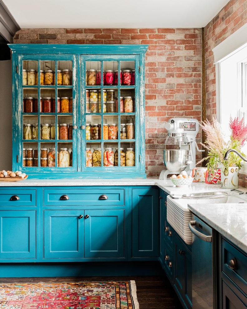 Huge farmhouse galley dark wood floor eat-in kitchen photo in Boston with a farmhouse sink, glass-front cabinets, distressed cabinets, brick backsplash, stainless steel appliances, quartz countertops, an island and red backsplash