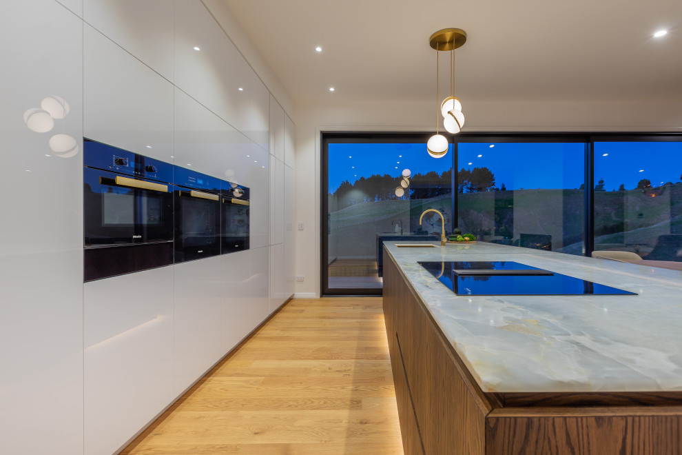 Large trendy galley open concept kitchen photo in Auckland with an island