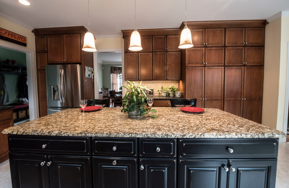 Example of a large transitional u-shaped porcelain tile and beige floor eat-in kitchen design in Philadelphia with an undermount sink, shaker cabinets, medium tone wood cabinets, granite countertops, beige backsplash, travertine backsplash, stainless steel appliances and an island