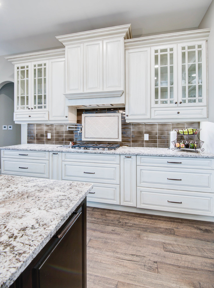 Example of a classic kitchen design in Calgary with shaker cabinets