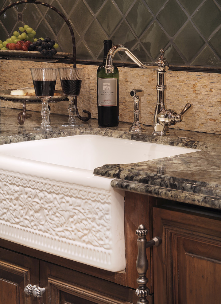 Tuscan kitchen photo in Phoenix with granite countertops, a farmhouse sink, dark wood cabinets, beige backsplash and glass tile backsplash