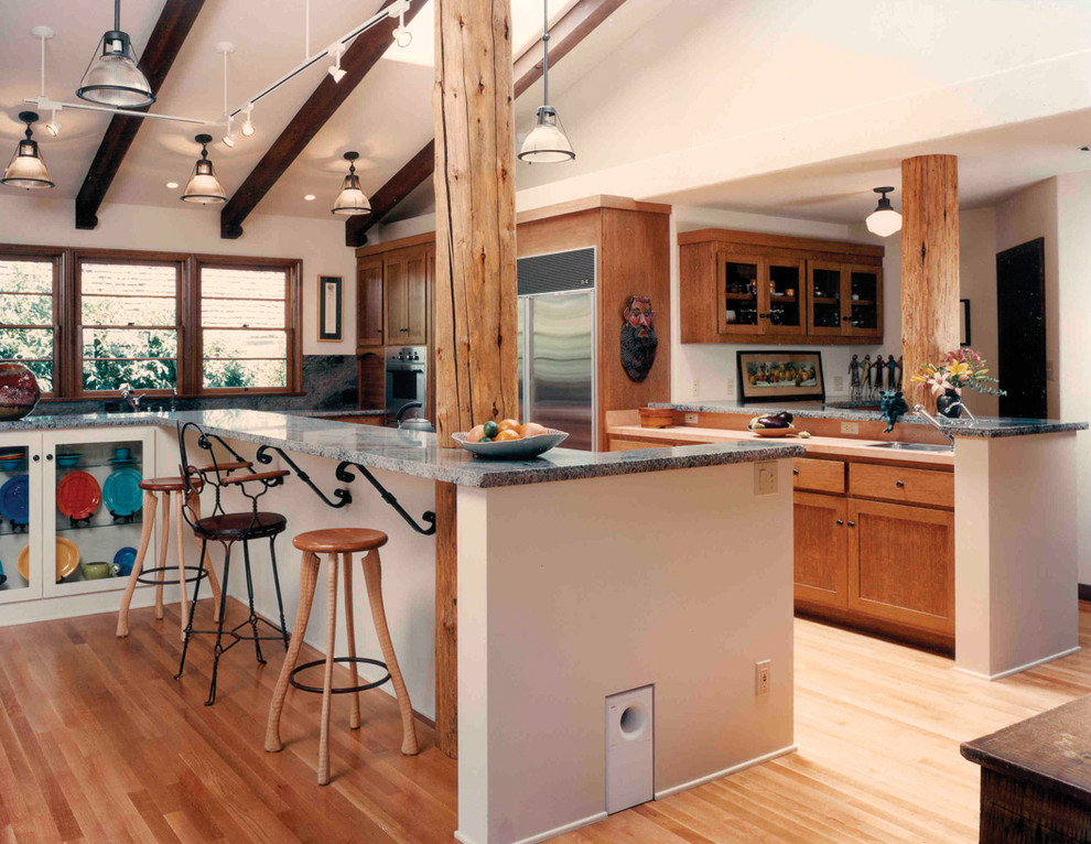 Inspiration for a mediterranean kitchen remodel in Los Angeles with shaker cabinets, medium tone wood cabinets and stainless steel appliances