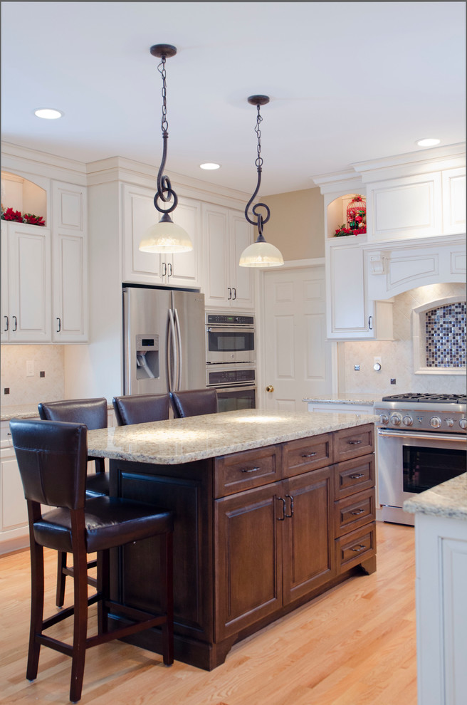 Example of a tuscan u-shaped eat-in kitchen design in Philadelphia with white cabinets, granite countertops, beige backsplash, subway tile backsplash and stainless steel appliances