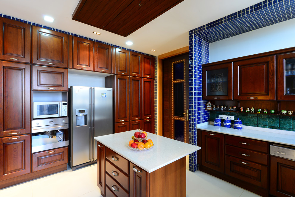 Example of a large tuscan l-shaped kitchen design in Hyderabad with raised-panel cabinets, dark wood cabinets, stainless steel appliances and an island