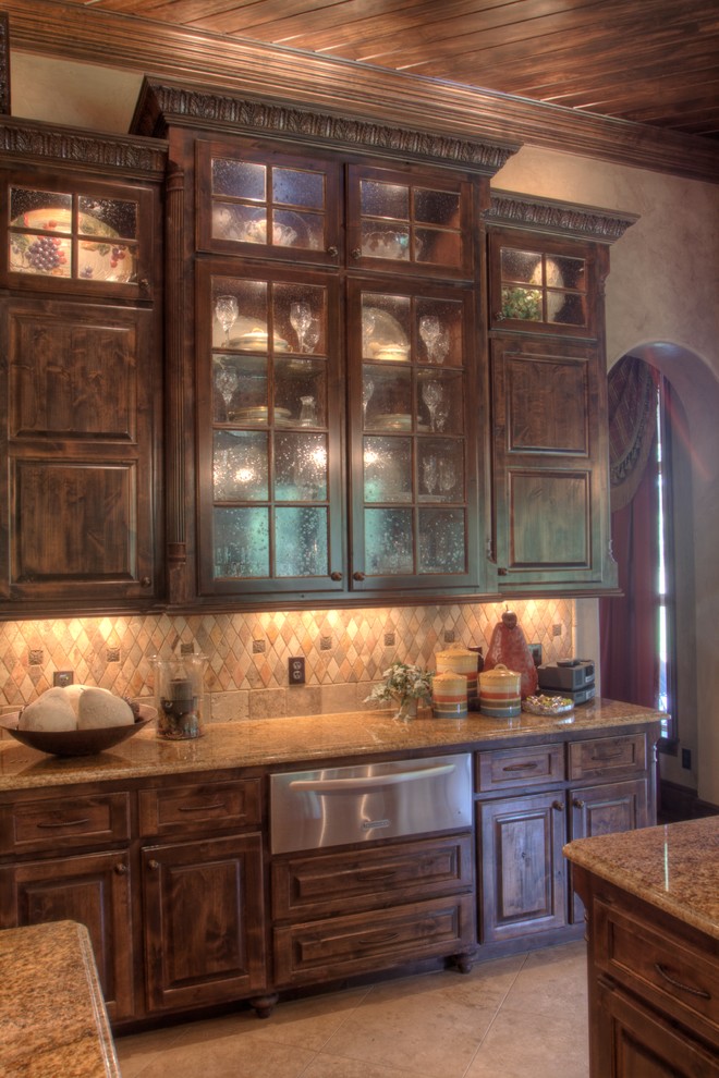 Example of a large tuscan u-shaped porcelain tile eat-in kitchen design in Austin with glass-front cabinets, medium tone wood cabinets, granite countertops, multicolored backsplash, ceramic backsplash, stainless steel appliances and an island