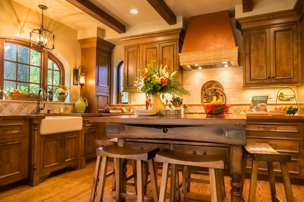Eat-in kitchen - small mediterranean l-shaped medium tone wood floor eat-in kitchen idea in St Louis with a farmhouse sink, shaker cabinets, medium tone wood cabinets, concrete countertops, beige backsplash, stone tile backsplash, stainless steel appliances and an island