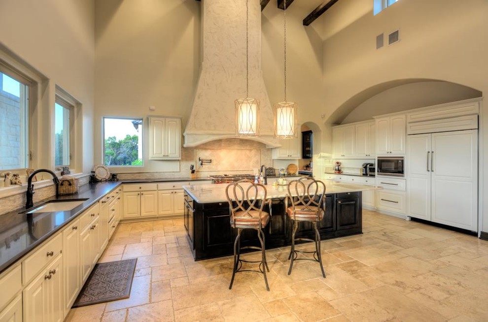 Inspiration for a large mediterranean u-shaped open plan kitchen in Austin with marble worktops, beige splashback, stone tiled splashback, travertine flooring and an island.