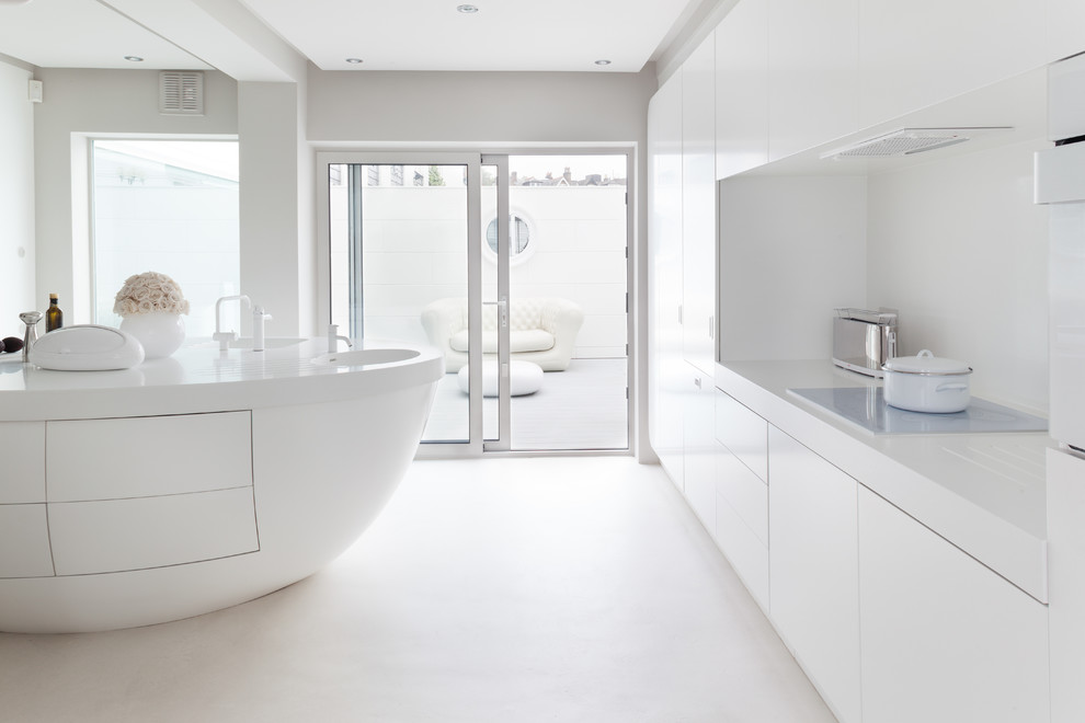 This is an example of a contemporary kitchen in London with flat-panel cabinets, white cabinets, white splashback and an island.