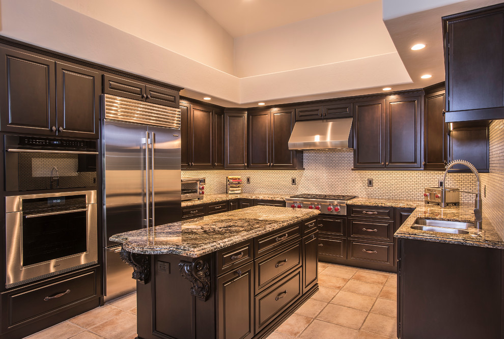 Example of a large classic u-shaped cement tile floor and beige floor kitchen pantry design in Phoenix with a double-bowl sink, raised-panel cabinets, dark wood cabinets, granite countertops, gray backsplash, matchstick tile backsplash, stainless steel appliances and an island