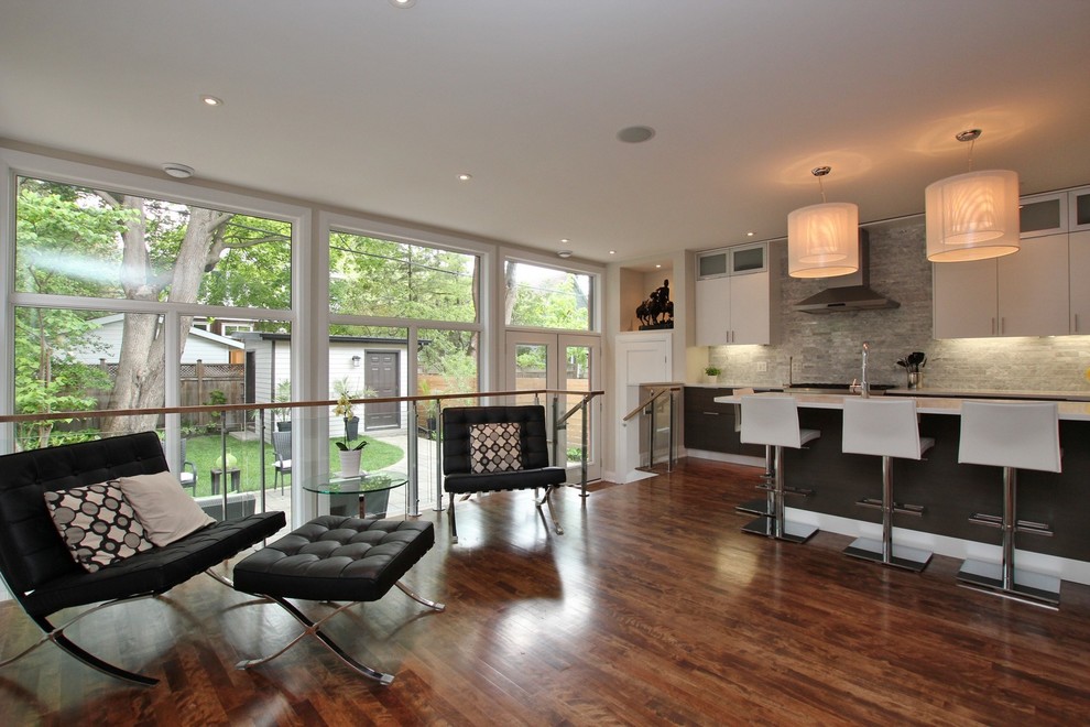 Example of a mid-sized trendy u-shaped medium tone wood floor and brown floor kitchen pantry design in Ottawa with an undermount sink, flat-panel cabinets, gray cabinets, gray backsplash, cement tile backsplash, stainless steel appliances, an island, quartz countertops and white countertops
