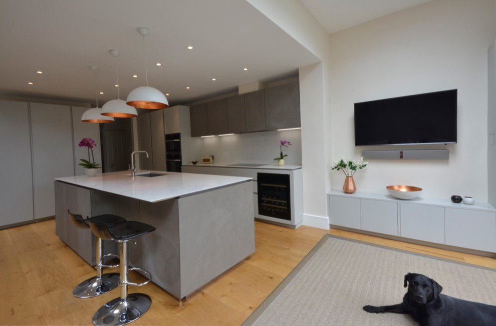 This is an example of a contemporary kitchen in London with composite countertops.