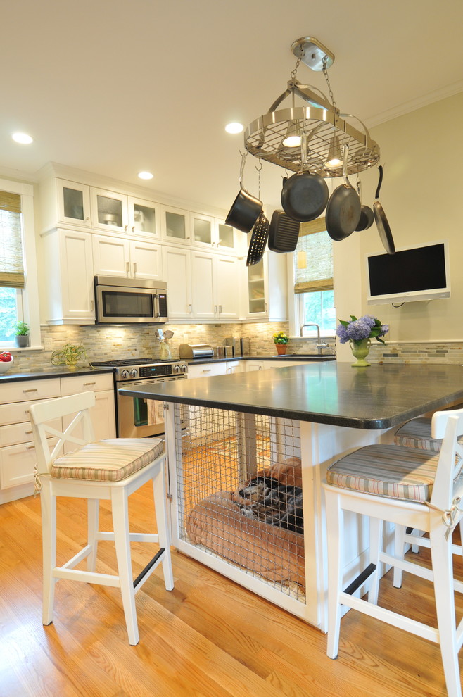 Example of a mid-sized transitional u-shaped light wood floor and brown floor eat-in kitchen design in Boston with recessed-panel cabinets, white cabinets, gray backsplash, stainless steel appliances, an undermount sink, matchstick tile backsplash, a peninsula, gray countertops and soapstone countertops