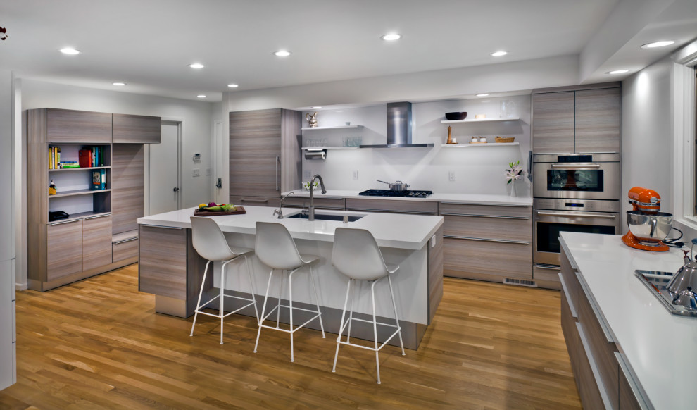 Inspiration for a large contemporary u-shaped medium tone wood floor and brown floor kitchen remodel in Minneapolis with an undermount sink, flat-panel cabinets, gray cabinets, quartz countertops, white backsplash, stone slab backsplash, paneled appliances, an island and white countertops