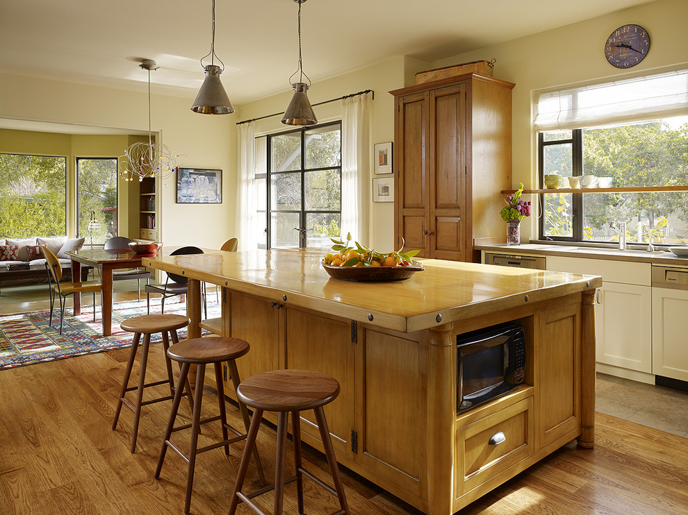 Photo of a traditional enclosed kitchen in San Francisco with wood worktops, raised-panel cabinets and medium wood cabinets.