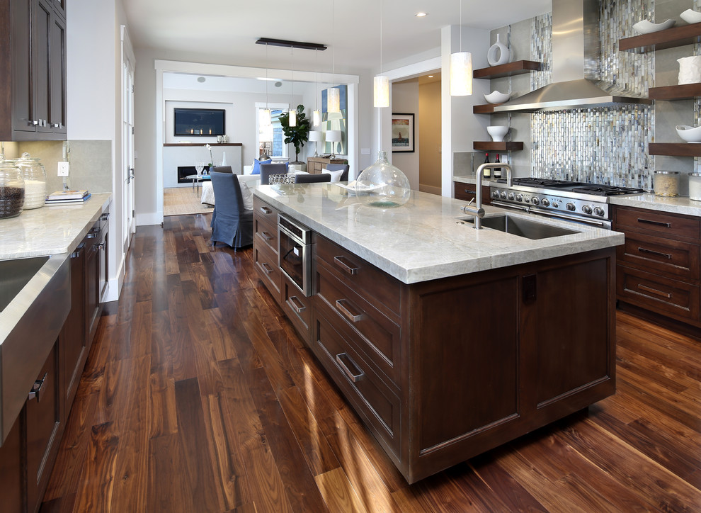 Inspiration for a large timeless galley medium tone wood floor eat-in kitchen remodel in San Francisco with a farmhouse sink, shaker cabinets, medium tone wood cabinets, quartzite countertops, gray backsplash, porcelain backsplash and stainless steel appliances