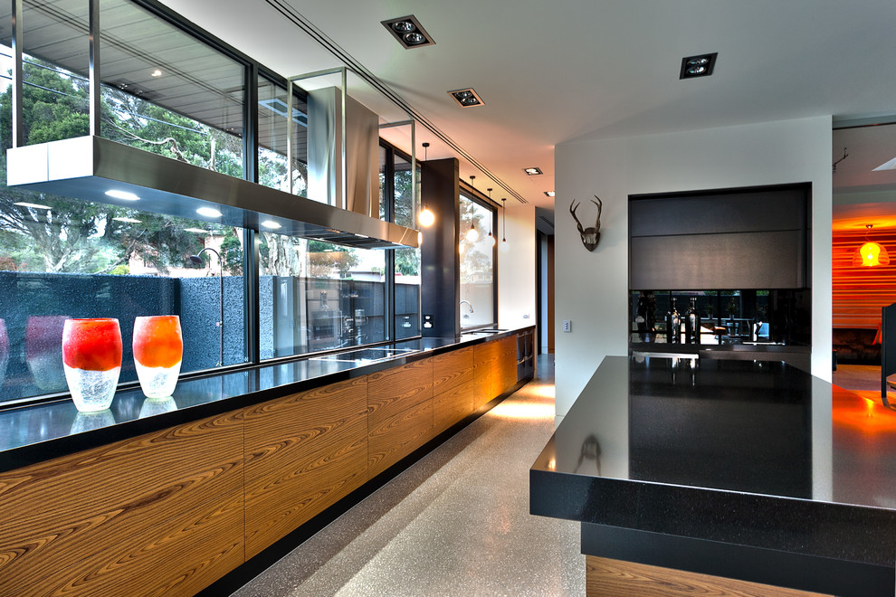 Идея дизайна: большая параллельная кухня в современном стиле с обеденным столом, черным фартуком, фартуком из стекла, островом и шторами на окнах