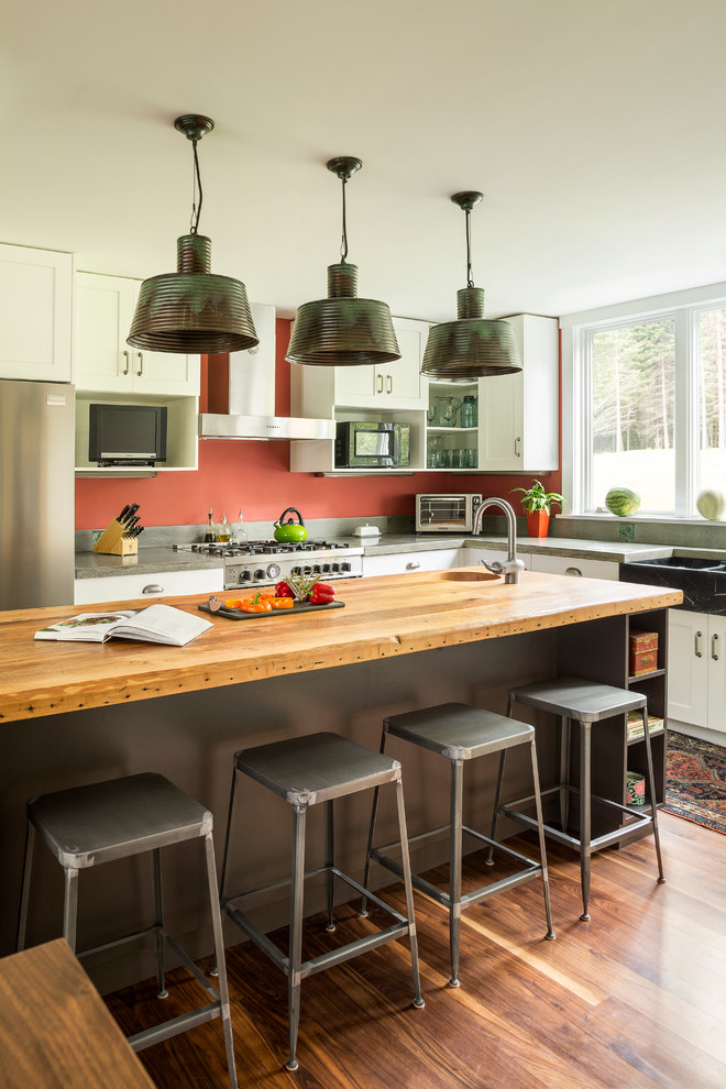 Kitchen - contemporary kitchen idea in Portland Maine with shaker cabinets, white cabinets, wood countertops, a farmhouse sink and stainless steel appliances