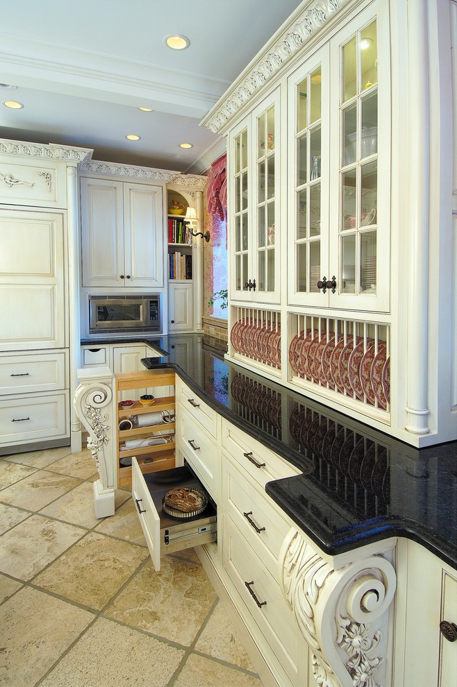 Klassisk inredning av ett stort kök, med en rustik diskho, luckor med upphöjd panel, vita skåp, granitbänkskiva, stänkskydd med metallisk yta, stänkskydd i metallkakel, integrerade vitvaror, kalkstensgolv, en köksö och beiget golv