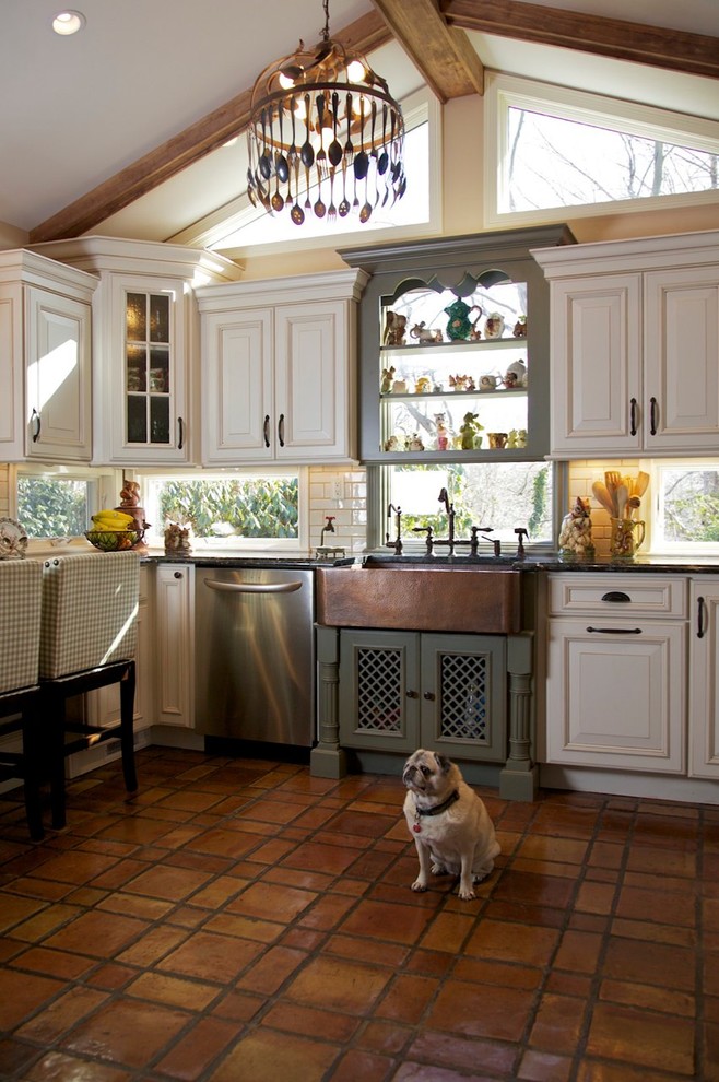 Large mountain style u-shaped terra-cotta tile enclosed kitchen photo in Huntington with stainless steel appliances, a farmhouse sink, raised-panel cabinets, beige cabinets, marble countertops and no island