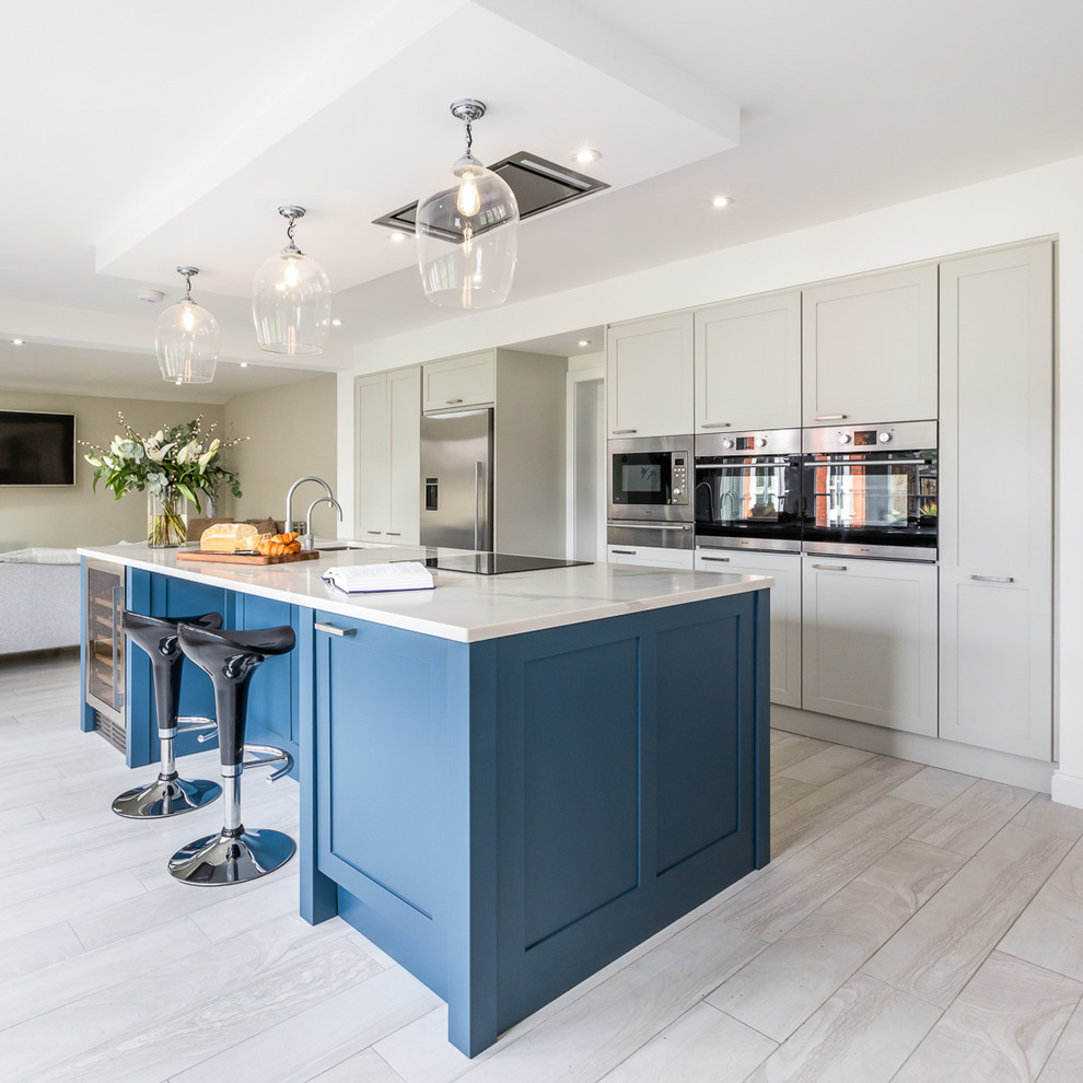 Design ideas for a contemporary open plan kitchen in Berkshire with shaker cabinets, quartz worktops, stainless steel appliances, an island and white worktops.