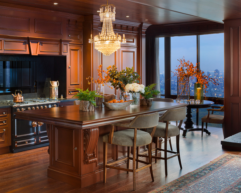 This is an example of a traditional kitchen in New York with recessed-panel cabinets and dark wood cabinets.