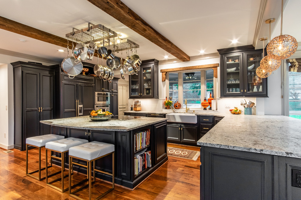 Inspiration for a huge timeless medium tone wood floor and brown floor kitchen remodel in Kansas City with a farmhouse sink, recessed-panel cabinets, blue cabinets, granite countertops, white backsplash, stainless steel appliances and an island