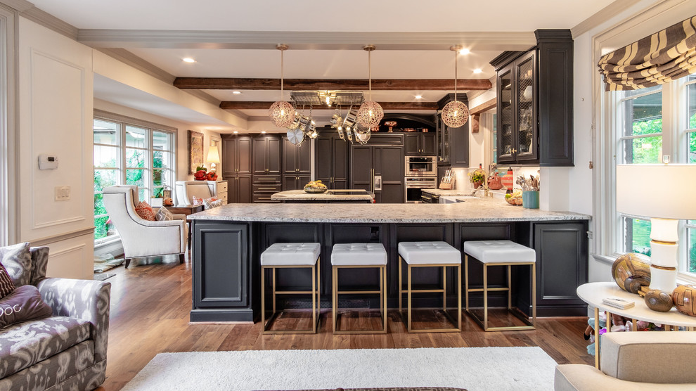 Design ideas for an expansive classic kitchen in Kansas City with a belfast sink, recessed-panel cabinets, blue cabinets, granite worktops, white splashback, stainless steel appliances, medium hardwood flooring, an island and brown floors.