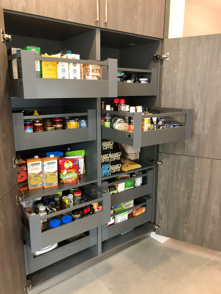 Photo of a traditional kitchen pantry in Houston with flat-panel cabinets, white cabinets, grey splashback, porcelain splashback, porcelain flooring, grey floors and yellow worktops.