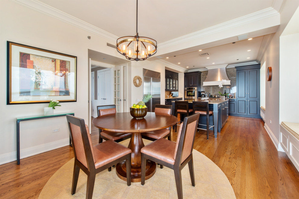 This is an example of a medium sized classic kitchen/dining room in Chicago with dark hardwood flooring and brown floors.