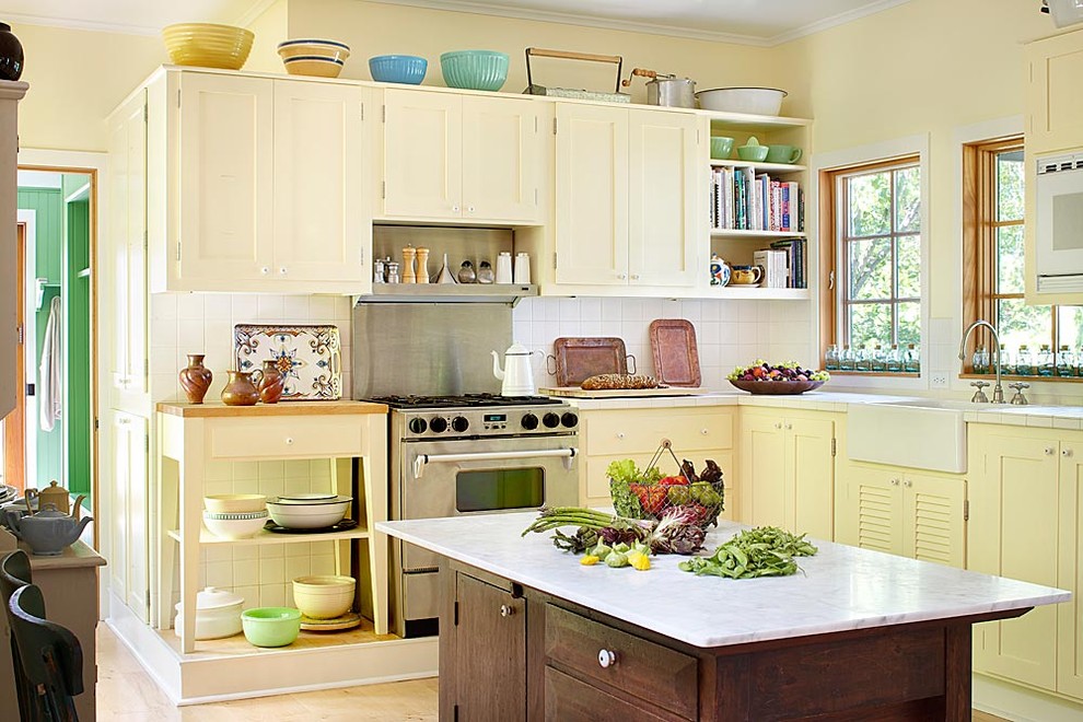 Inspiration for a timeless kitchen remodel in Chicago with stainless steel appliances, a farmhouse sink and yellow cabinets