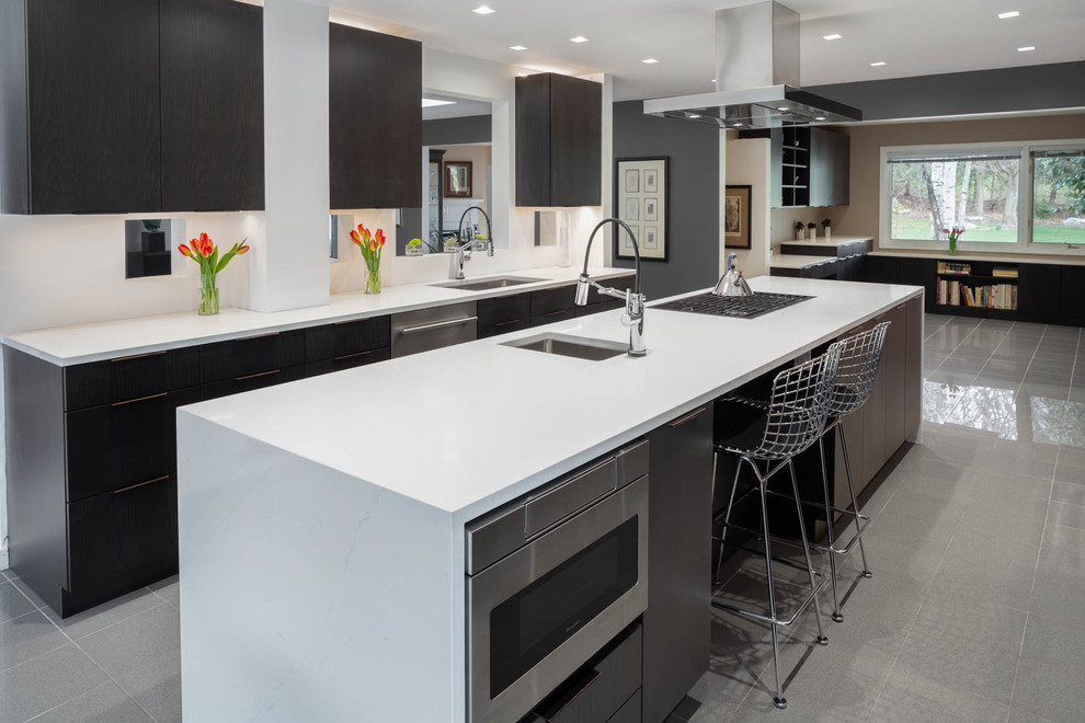 Large contemporary u-shaped kitchen in Other with a submerged sink, flat-panel cabinets, brown cabinets, engineered stone countertops, brown splashback, stainless steel appliances, marble flooring, an island, grey floors and white worktops.